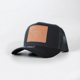 Black A-Frame baseball cap featuring a tan leather Lost Calf logo patch on the front and black mesh back.