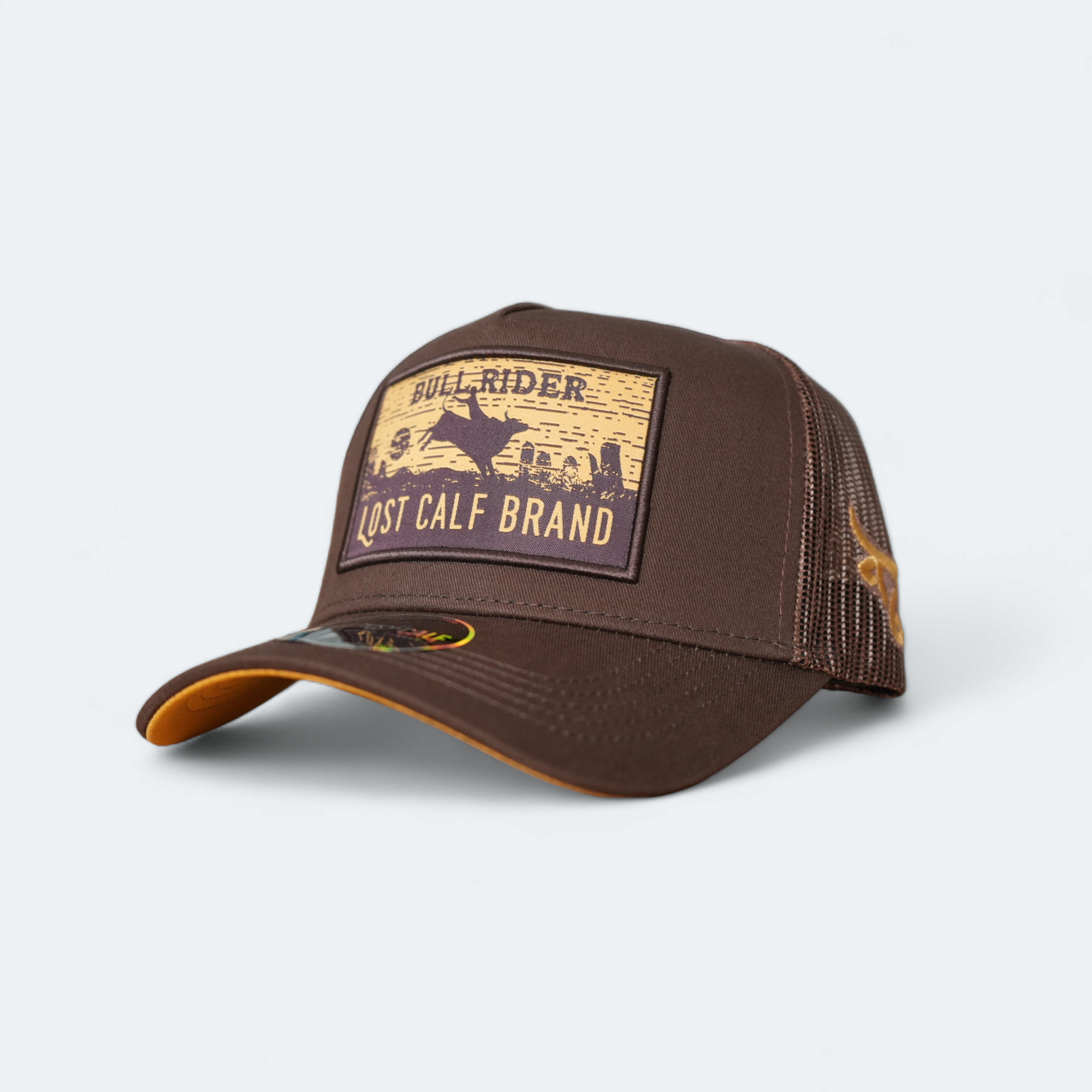A brown one-tone baseball cap with the 'Bullrider Lost Calf' branded patch on the front and a mesh brown back.