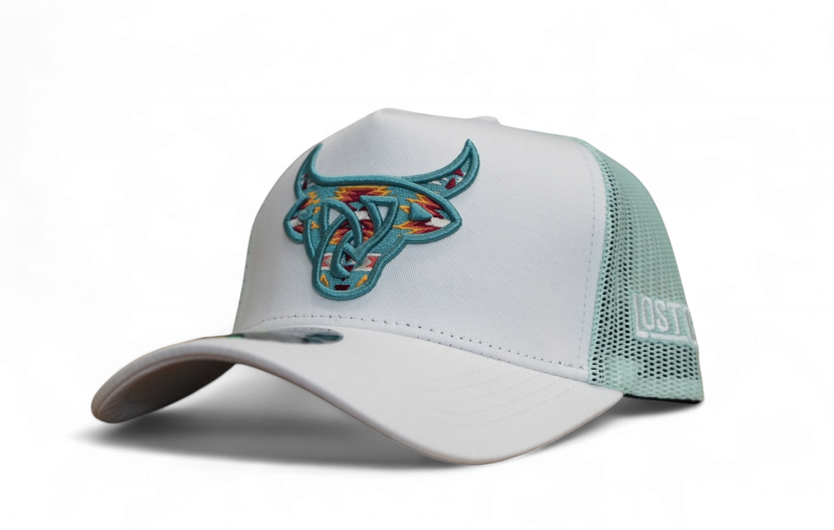 White A-Frame trucker hat with light blue mesh back and 3D Lost Calf logo featuring a colorful Aztec embroidery design.