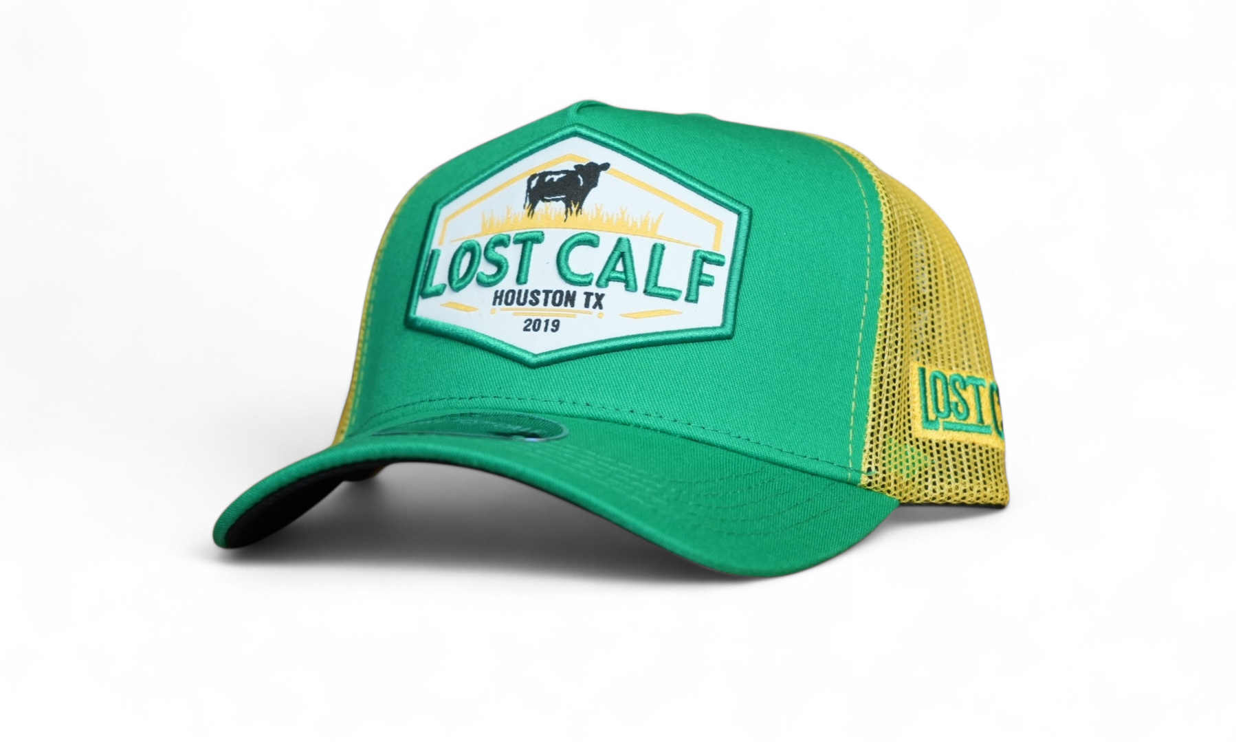 Green and yellow A-Frame cap with a farm patch stating 'Lost Calf Houston TX' 